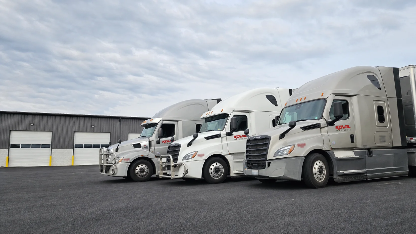 Koval Trucking fleet parked at the company shop